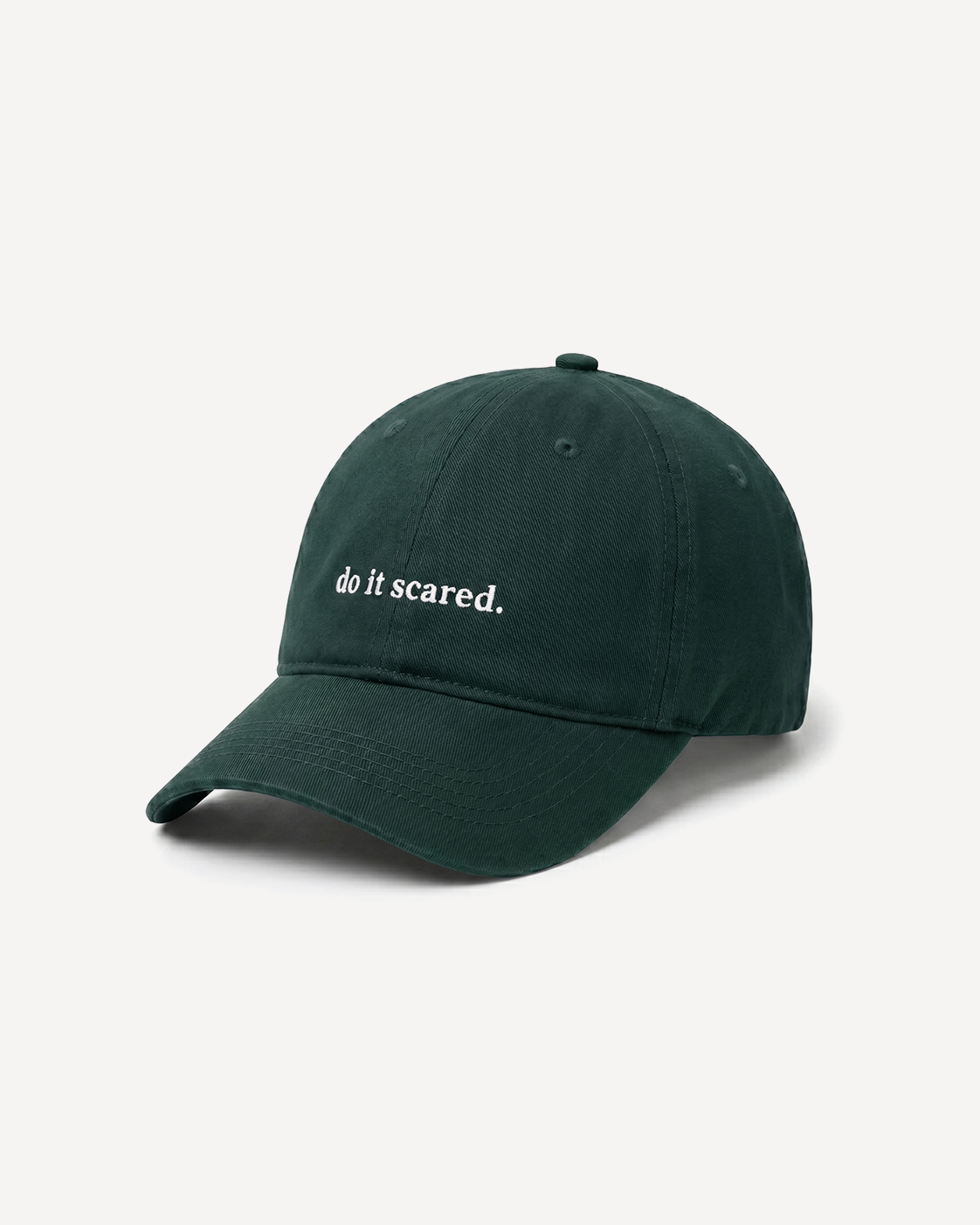Green cap with 'do it scared.' text on a white background